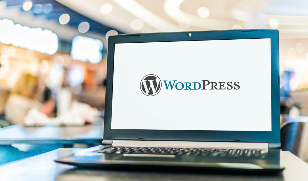 image of a laptop computer displaying the WordPress logo
