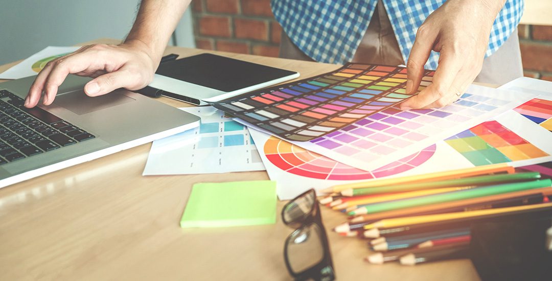 image of branding and graphic designer looking at color swatches